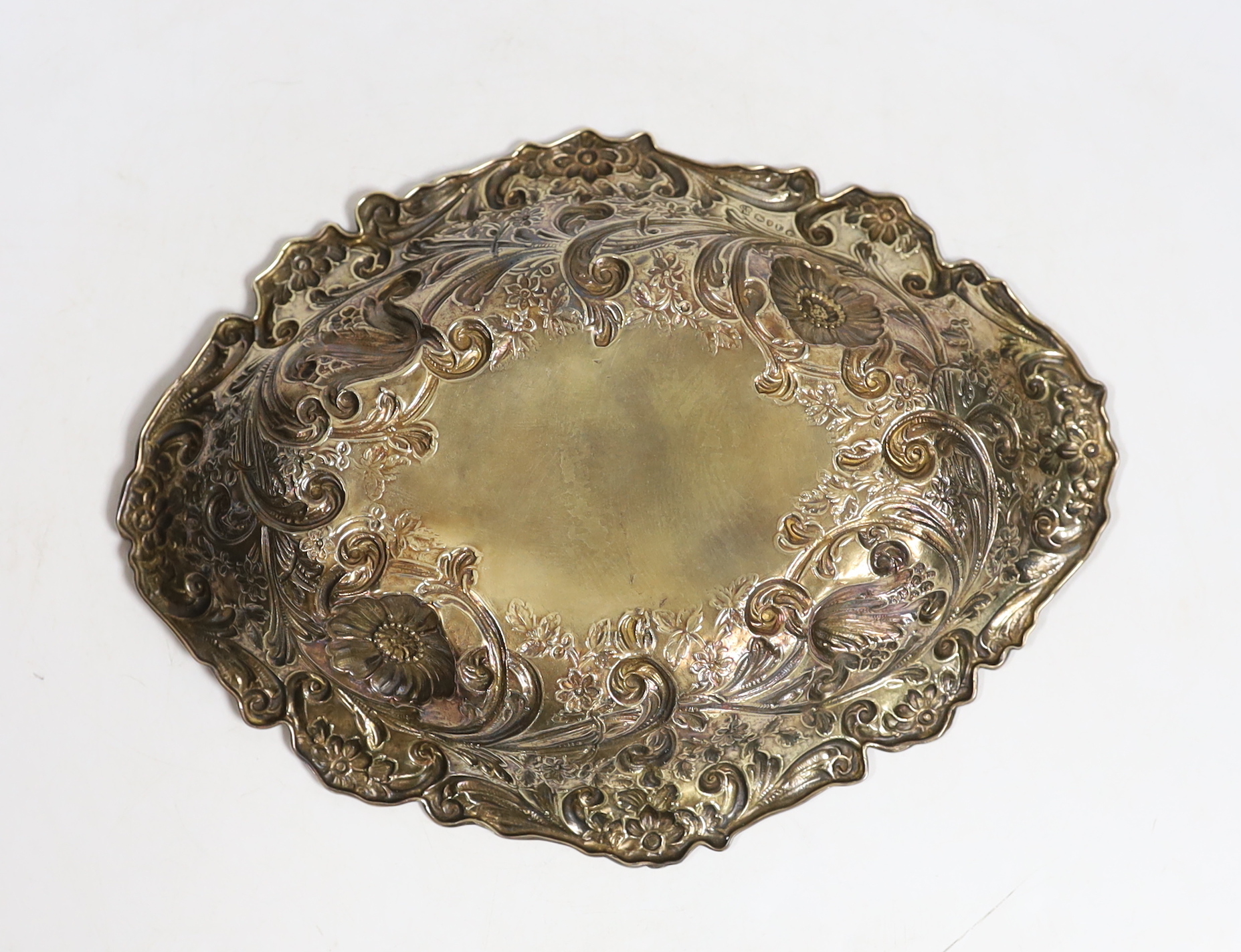 A late Victorian embossed silver gilt oval dish, by Charles Stuart Harris, London, 1886, 27cm, 8.2oz.